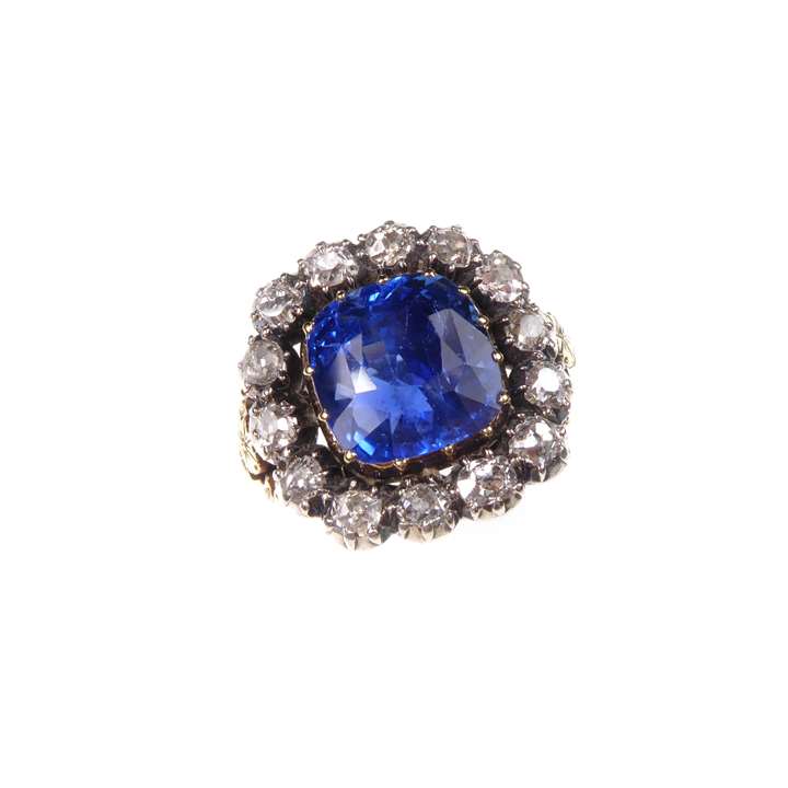 Sapphire and diamond cluster ring, centred by a cushion cut Ceylon sapphire